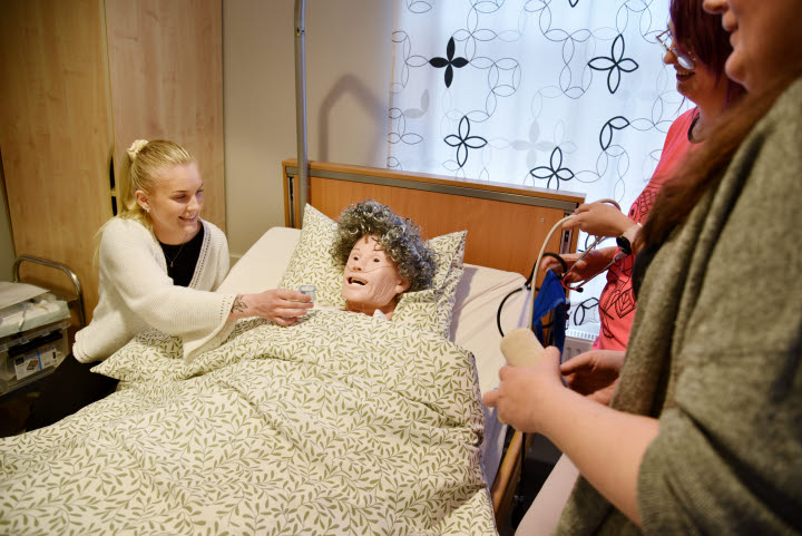 Elin Norberg ger omvårdsdockan medicin på metodrummet på VUX.