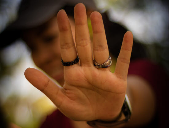 20811762-out-of-focus-woman-with-her-hands-signaling-to-stop-on-bokeh-background.jpg