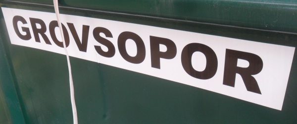 En grön container där det står "Grovsopor" med svart text på vit bakgrund.
